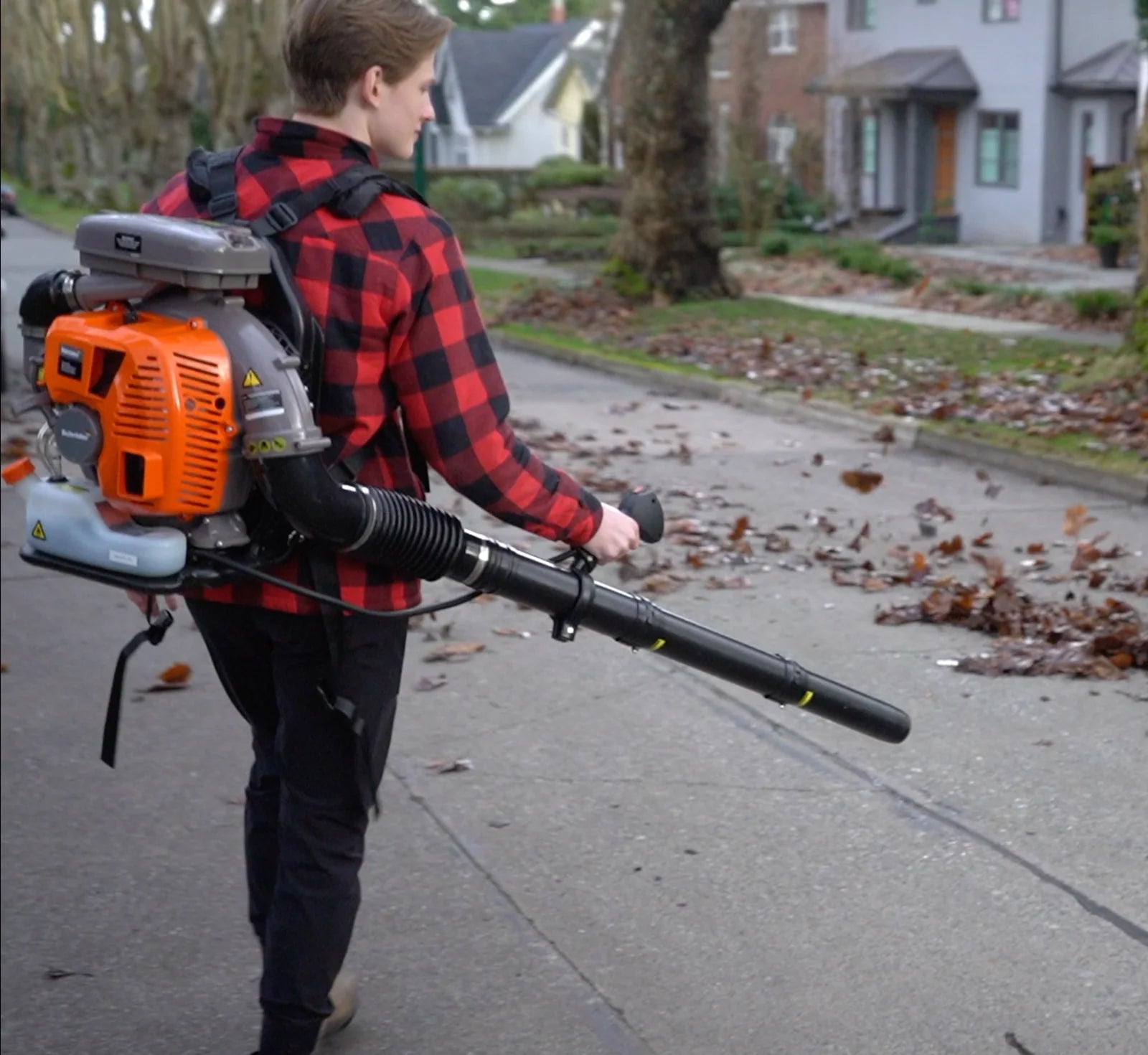 Operator clearing wet leaves with a Schröder backpack blower